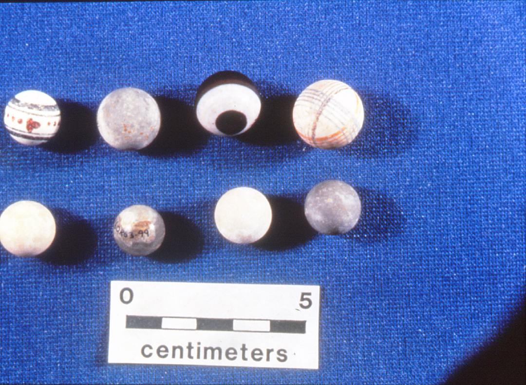 Clay marbles, some with hand-Painted decoration, from excavated context
