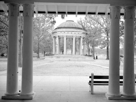 Sitting in the shade, under the Casino Building, looking towards the park's bandstand, donated by John Popp.