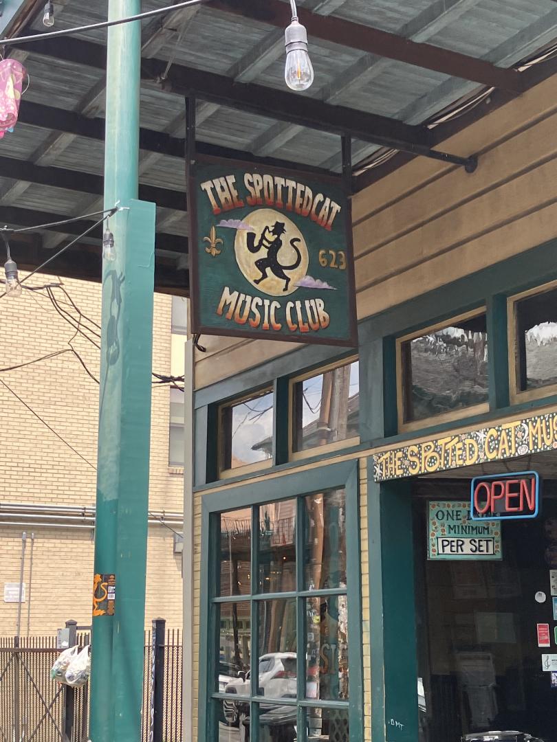 The sign hanging over The Spotted Cat.