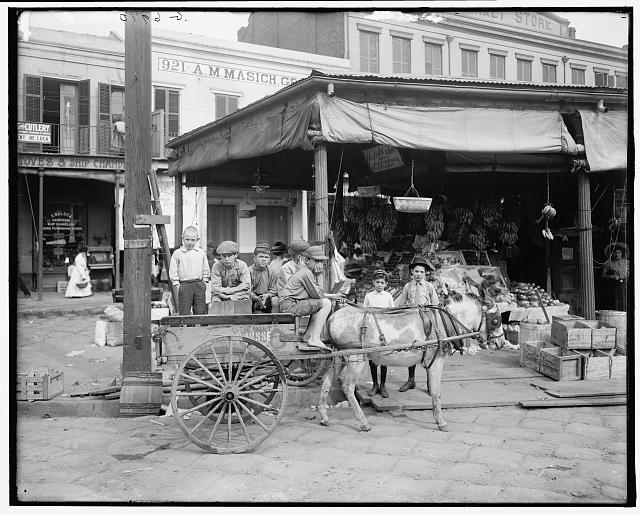 Children aboard produce wagon, French Market